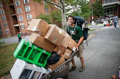 Photograph of college freshman moving into dorm